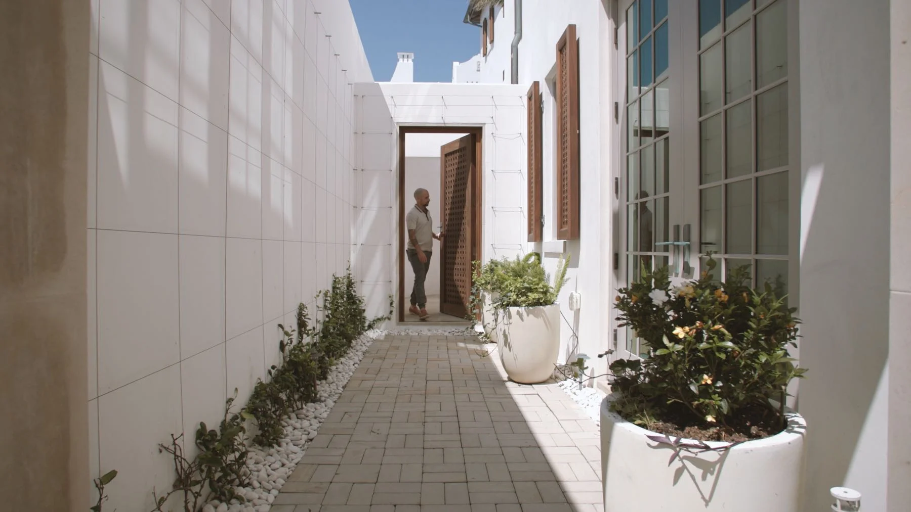 Ipe Shutters and Courtyard Gate – E. F. San Juan Ipe wood shutters and courtyard gate in Alys Beach Florida
