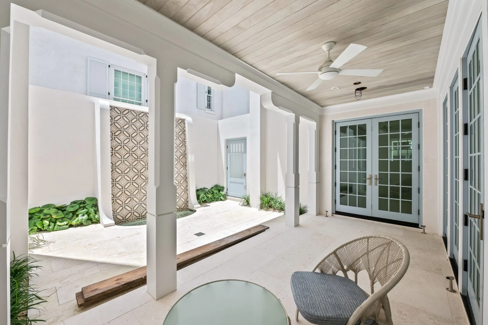 Old Cellar Lane Courtyard Patio – Alys Beach Millwork by E. F. San Juan Loewen hurricane-rated glass doors and ceiling parts provided by E. F. San Juan for Alys Beach courtyard