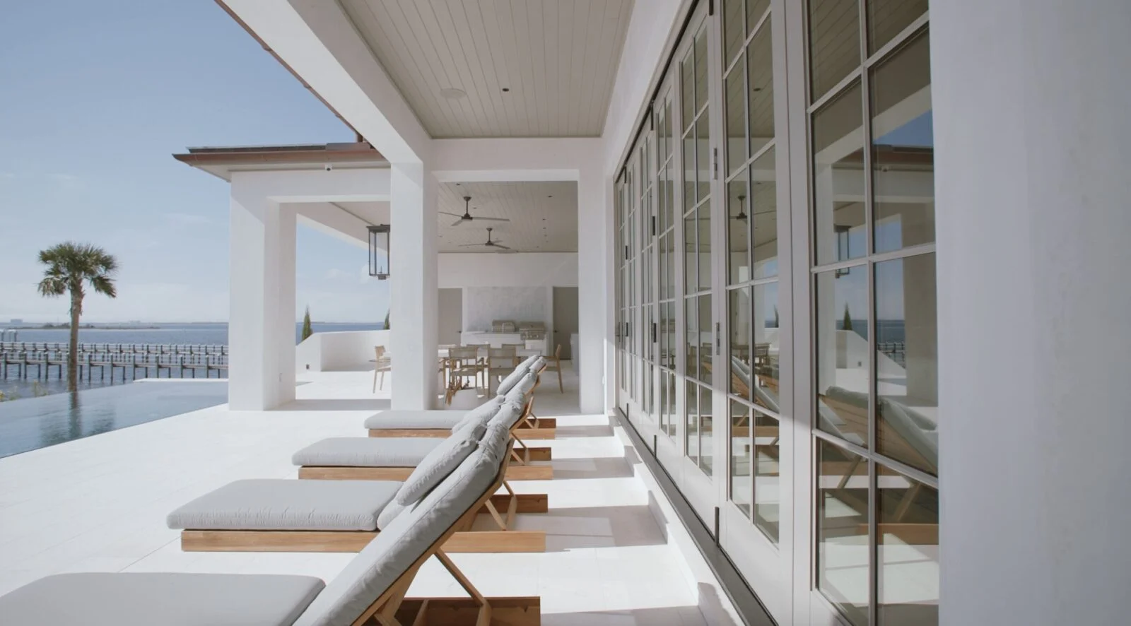 Modern Home on North Shore Island Panama City – Exterior Glass Doors Weather Shield hurricane-rated exterior doors on a bayfront custom home in Panama City, Florida
