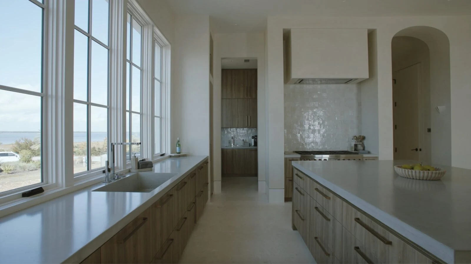 Modern Home on North Shore Island Panama City – Kitchen Kitchen design and a view of the bay from a luxury home in Panama City, Florida, featuring cabinetry and Weather Shield windows by E. F. San Juan