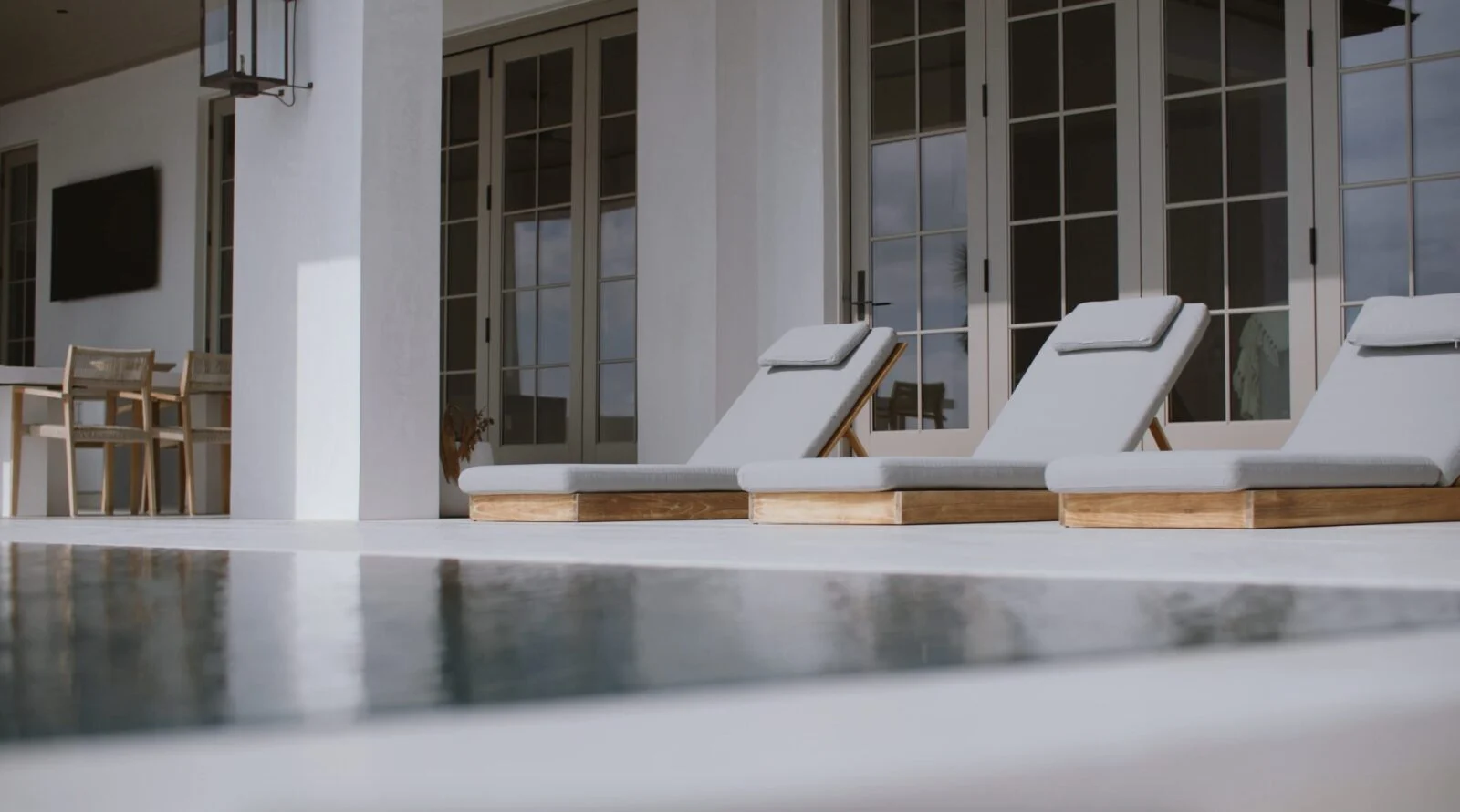 Modern Home on North Shore Island Panama City – Pool Deck Pool view and exterior Weather Shield hurricane-rated doors for a custom home in Panama City, Florida
