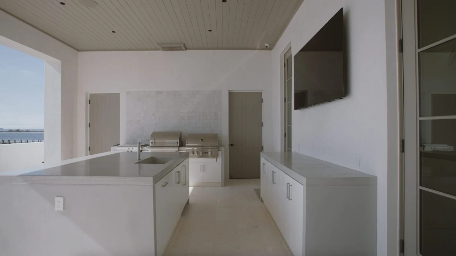 Modern Home on North Shore Island Panama City – Outdoor Kitchen Outdoor kitchen of a Wes Seaborn-designed custom home in Panama City, Florida, with millwork, windows, and doors by E. F. San Juan